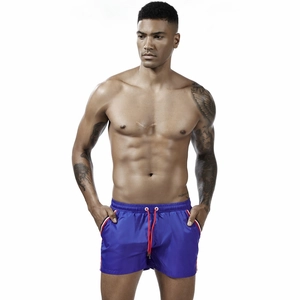 Men's royal blue quick-dry running shorts with elastic waist and tri-color side stripes