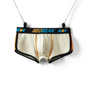 Detail of men's low-waisted trunks with ergonomic U-pouch and orange contrast stitching