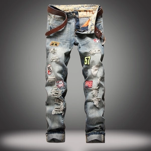 Men's light blue straight leg distressed jeans with embroidery patches and brown belt