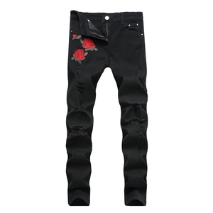 Men's slim fit black ripped jeans featuring red rose embroidery and distressed denim details