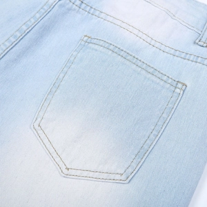 Detailed macro view of high-waist denim jeans back pocket with yellow stitching