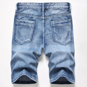 Detail of light blue denim shorts back showing dual pockets and vintage stitching