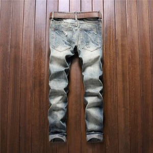 Distressed straight leg men's jeans in vintage blue with worn details and brown belt