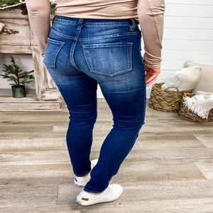 Slim fit high waist dark blue denim jeans for women showing the back view and pockets