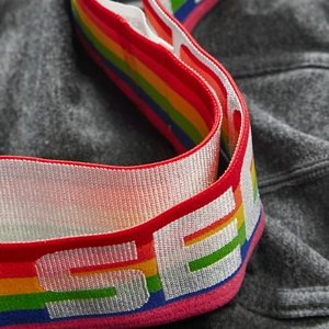 Macro shot of colorful rainbow elastic waistband with silver brand logo lettering