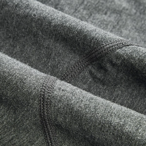 Macro detail of dark grey knit fabric with reinforced flatlock stitching on men's boxers