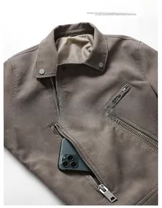 Detail of men's faux leather jacket showing shoulder snaps and zipper pocket with phone