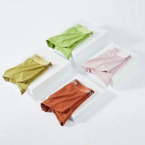 Detailed display of four colorful knit cotton boxer briefs on minimalist display blocks