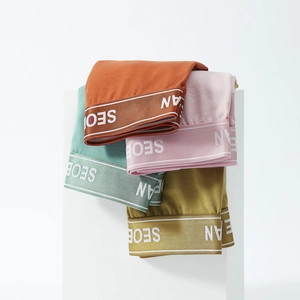 Detail view of four-pack men's knit boxer briefs in vibrant colors with elastic waistbands