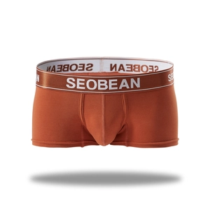 Detail of men's orange knitted boxer briefs featuring elastic waistband and 3D pouch