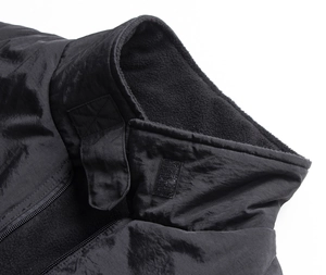 Close-up of windproof neck collar with hook and loop fastener on black outdoor vest