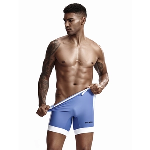 Close-up of light blue men's fitness bodysuit featuring white piping and Tauwell logo