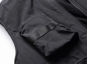 Close-up of tactical zipper pocket on men's black vest with warm fleece lining inside