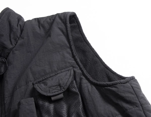 Detail of outdoor vest featuring fleece lining and functional mesh utility pockets