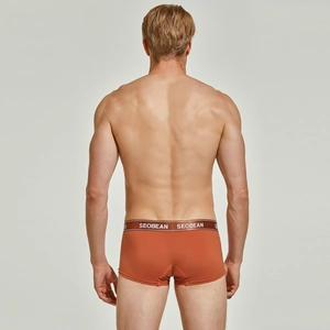 Rear view of orange men's boxer briefs showing seamless fit and logo waistband