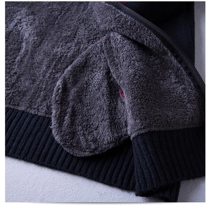 Detail showing plush fleece lining and ribbed hem of the men's knit sweater