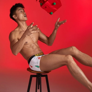 Close-up of men's low-waist boxer shorts with festive Christmas tree print and elastic waistband