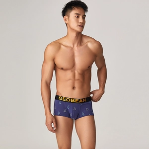 Close-up of low-waist boxer briefs with blue geometric patterns and elastic waistband