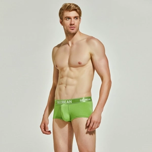 Detailed close-up of men's green knit boxer briefs with a flexible elastic waistband