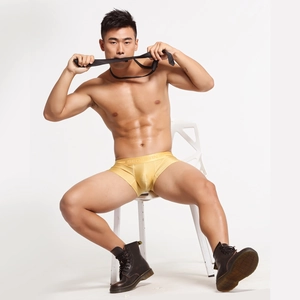 Close-up of men's yellow low-rise trunks featuring a breathable U-convex pouch design