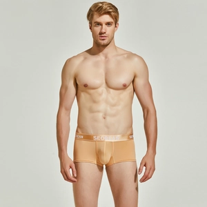 Detailed close-up of light orange knitted men's boxer briefs with elastic brand waistband