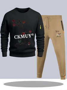 Flat lay of men's black tracksuit set featuring rose print hoodie and khaki joggers