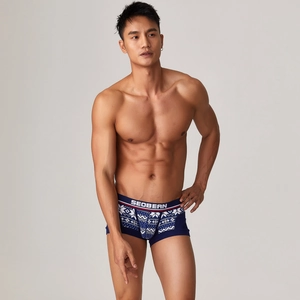Detail view of men's low-rise boxer briefs with blue geometric print and elastic waistband