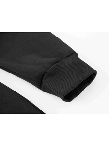 Detailed macro shot of high-density black ribbed cuffs on a men's sports hoodie sleeve