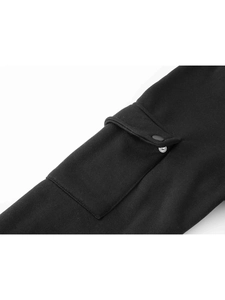 Close-up of cargo pocket with snap button on black knit tracksuit sleeve and fabric texture