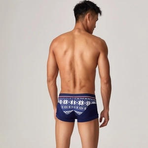 Detail of navy blue boxer briefs with white snowflake patterns on the back of the waistband