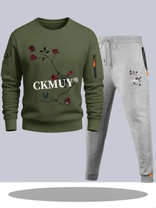 Detail of olive green hoodie with floral print and gray joggers with orange zipper pockets