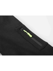 Detail of black sports hoodie with vibrant neon zipper pulls and knit texture detail