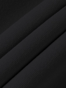 Close-up of premium black knitted cotton fabric texture with fine weave patterns