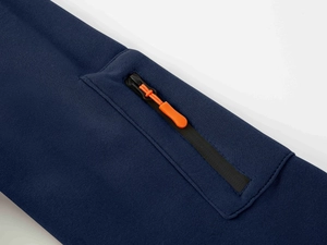 Close-up of navy sports hoodie sleeve featuring a black zipper with bright orange puller