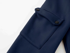 Detail of cargo pocket with double matte snap buttons on dark blue sports hoodie