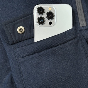 Detail of navy knit hoodie showing snap flap pocket and large phone storage compartment