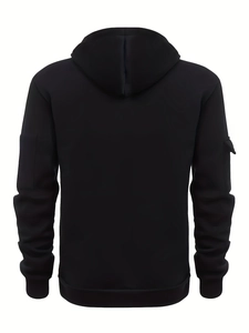 Rear view of black hooded sweatshirt featuring utility sleeve pocket and ribbed hems