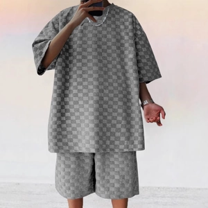 Close-up of gray checkerboard pattern fabric texture on a relaxed men's streetwear set