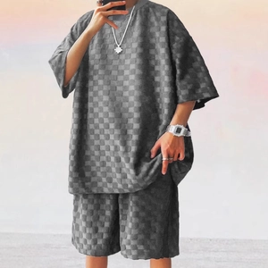 Detail of grey oversized men's two-piece set with embossed checkerboard waffle texture