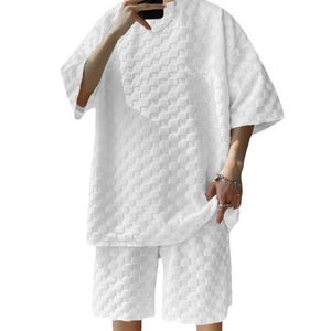 Detail of white men's oversize waffle texture knit t-shirt and shorts two-piece set