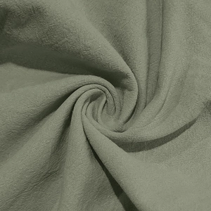 Close-up detail of grey-green cotton linen fabric with natural cross-weave texture
