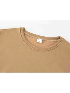 Macro detail of ribbed crew neck and soft fleece lining on light brown sweatshirt