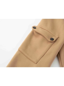 Close-up of khaki sweatshirt pocket with dual matte black snap buttons and cargo flap