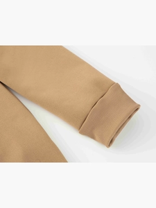 Detailed macro shot of the ribbed cuff on a camel brown casual sweatshirt