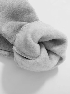 Close-up of gray knit fabric showing the soft fleece lining and high-quality stitching