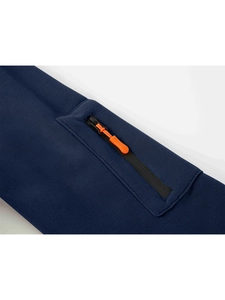 Detail of navy sweatshirt featuring a zip pocket with a bright orange puller accent