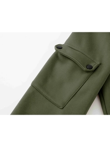 Detail view of military green sweatshirt featuring a flap pocket with two black snap buttons