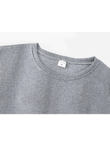 Detailed close-up of grey sweatshirt crew neck with size label and fabric texture