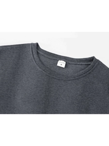 Detail of grey crewneck sweatshirt rib collar with size M label and neat stitching
