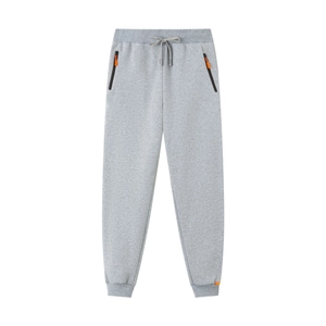 Détails du jogging gris avec poches zippées, tirettes orange et taille à cordon serrage